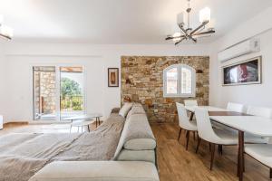 a living room with a couch and a dining room table at Siar The Large Villa by PikHost in Borsh