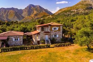 an image of a house with mountains in the background at Siar The Large Villa by PikHost in Borsh