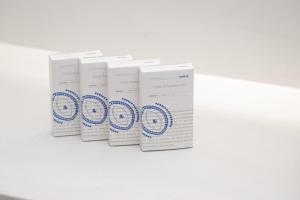 four white boxes sitting on a white table at À La Plage Residences 03 in Platis Gialos