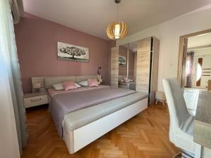 a bedroom with a large bed and a mirror at New apartment Dany with parking for two in Split