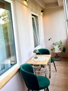 a room with a table and chairs and a window at Freshly Renovated Black & Sand Studio in Liepāja
