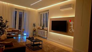 a living room with a television on a wall at La casa del sole in Trofarello
