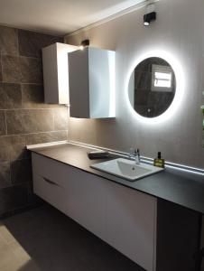 a kitchen with a sink and a mirror at La terrasse de Bonne terre in Saint-Claude +11 photos