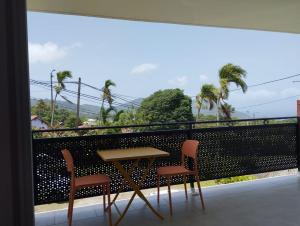 a table and two chairs on a balcony at La terrasse de Bonne terre in Saint-Claude