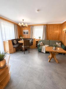 a living room with a couch and a table at Haus Alpenecho in Mittelberg