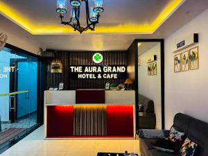 a lobby of a hotel and cafe with a reception desk at The Aura Grand Hotel and Cafe in Patna