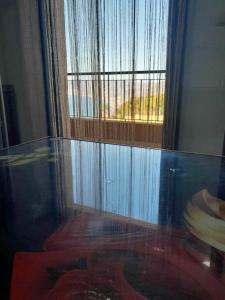 a glass table in a room with a window at اقامة جاد in Oran