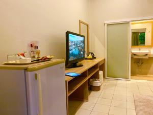 a room with a television on a desk with a sink at Spice & Sea Resort in Kata Beach +51 photos