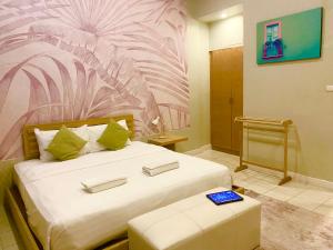a bedroom with a large bed with a pink flower mural at Spice & Sea Resort in Kata Beach
