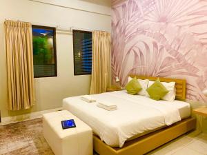 a bedroom with a bed with a pink flower wallpaper at Spice & Sea Resort in Kata Beach