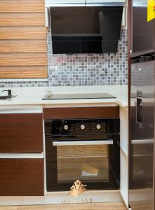 a kitchen with a black oven and a microwave at ORIGAMI APARTMENTs in Boi +15 photos