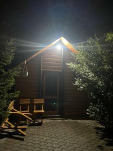 a cabin with a light on top of it at night at Vila Gryka in Peje