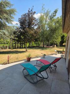 two chairs and a table on a patio at Les Perriers in Chambray-lès-Tours