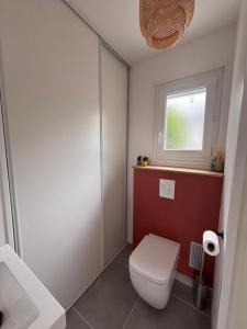 a bathroom with a toilet and a window at Maison a Socoa in Urrugne +27 photos