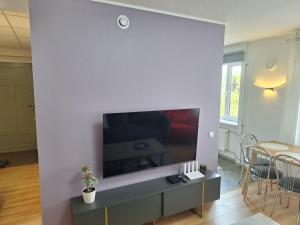 a living room with a flat screen tv on a wall at Spacious & sunny apartment with a balcony in Tartu