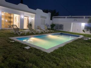 a swimming pool in the yard of a house at night at Dar Emna in Hammamet