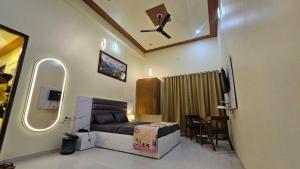 a small bedroom with a bed and a table at Hotel gl palace & restaurant chomu in Jaipur