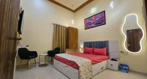 a bedroom with a bed and a table and chairs at Hotel gl palace & restaurant chomu in Jaipur