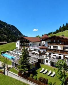 an aerial view of a resort with a swimming pool at Berghotel Almrausch in Berwang