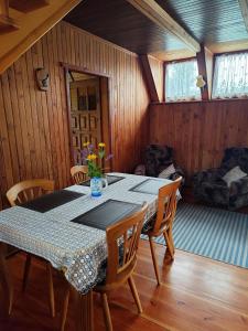 a dining room with a table and chairs at U Cecylii in Rowy