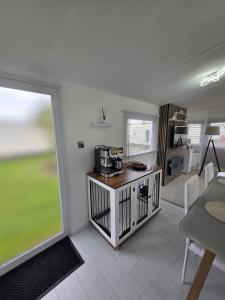 a living room with a coffee maker on a counter at Carlys Cosy Caravan in Cresswell