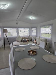 a living room with a table and a couch at Carlys Cosy Caravan in Cresswell