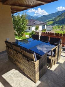 a picnic table on a patio with a view of the mountains at Putz Appartements in Gröbming