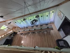 a room with two beds and a chandelier at KLĀNU MĀJA in Varakļāni