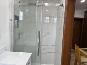 a shower with a glass door in a bathroom at Downtown Residance Room 2 in Guelph