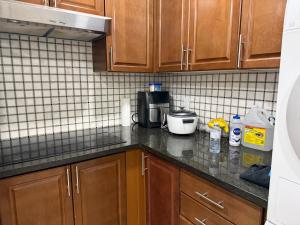 a kitchen with wooden cabinets and a counter top at Downtown Residance Room 2 in Guelph