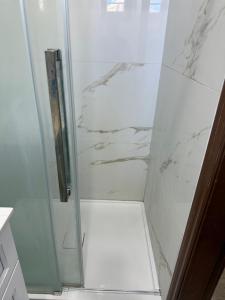 a shower with a glass door in a bathroom at Downtown Residance Room 2 in Guelph