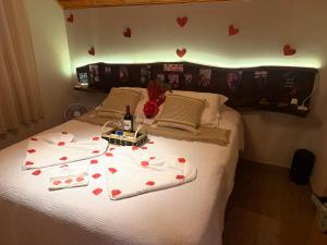a bedroom with a bed with hearts on it at Chalé Recanto do Quilombo - MV in Camanducaia