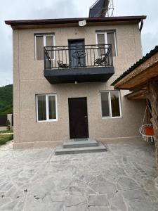 a house with a balcony on top of it at Gogasar house in Ijevan