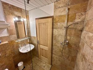 a bathroom with a sink and a shower at Gasthof Kronreith in Maria Alm am Steinernen Meer +25 photos
