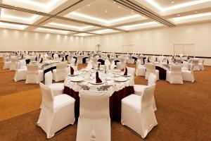 a large banquet hall with white tables and white chairs at Holiday Inn Mexico City-Plaza Universidad by IHG in Mexico City