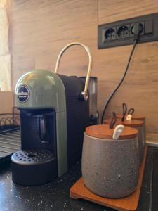 a coffee maker sitting on a counter next to a cup at Mountain house in Žabljak