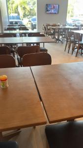 a row of tables and chairs in a cafeteria at UMARI Reserva Hotel in Marituba +3 photos