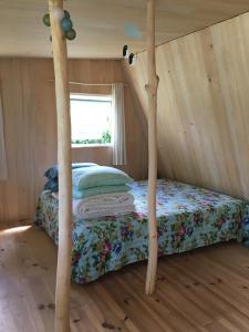 a bedroom with a bed in a room at Les Jardins d'Yzorche in Saint-Bazile-de-la-Roche