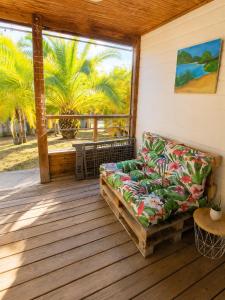 a couch sitting on a porch with a window at Au Paradis de Peggy - Bungalow 5 pers - Village de la Pointe Faula in Le Vauclin