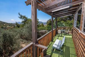 a wooden deck with chairs and a table on it at נוף ארץ הגליל - צימרים מהממים במצפה נטופה in Mitspe Netofa