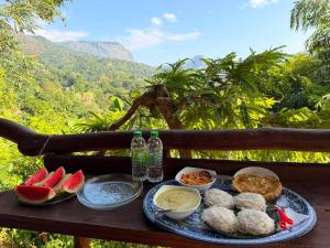 a tray of food sitting on a table with watermelon at Ella Sky Cabana in Ella +52 photos