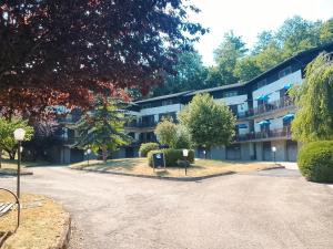 an apartment building with a driveway in front of it at Mulinaccio Appartamenti in Pievepelago