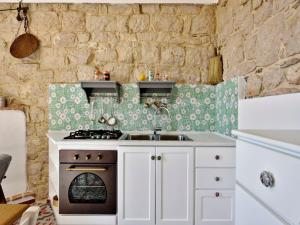 a kitchen with a sink and a stove at Sunset Baunei in Baunei