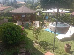 a backyard with a hot tub and a gazebo at Casa vacanza luisa in Sezze