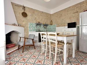 a kitchen with a table and chairs and a fireplace at Sunset Baunei in Baunei