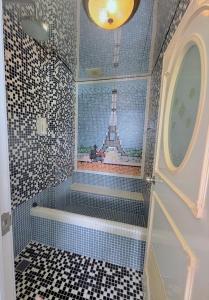 a bathroom with a walk in shower with a tower on the wall at 燈塔情人歐風海景民宿 in Eluan +35 photos