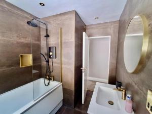 a bathroom with a sink and a mirror at The Waterfront House in Kinsale, hosted by Exquisite Holiday Homes in Dunderrow +41 photos