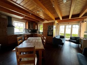 a kitchen and dining room with a wooden table at Ostseebauernhof Schönhagen in Brodersby