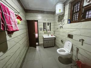 a bathroom with a toilet and a sink at Dhauladhar Vista in Pālampur +34 photos