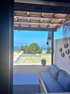 a living room with a couch and a view of the ocean at Maison de plage Marsa M'diq 2 chambres et Salon in M'diq